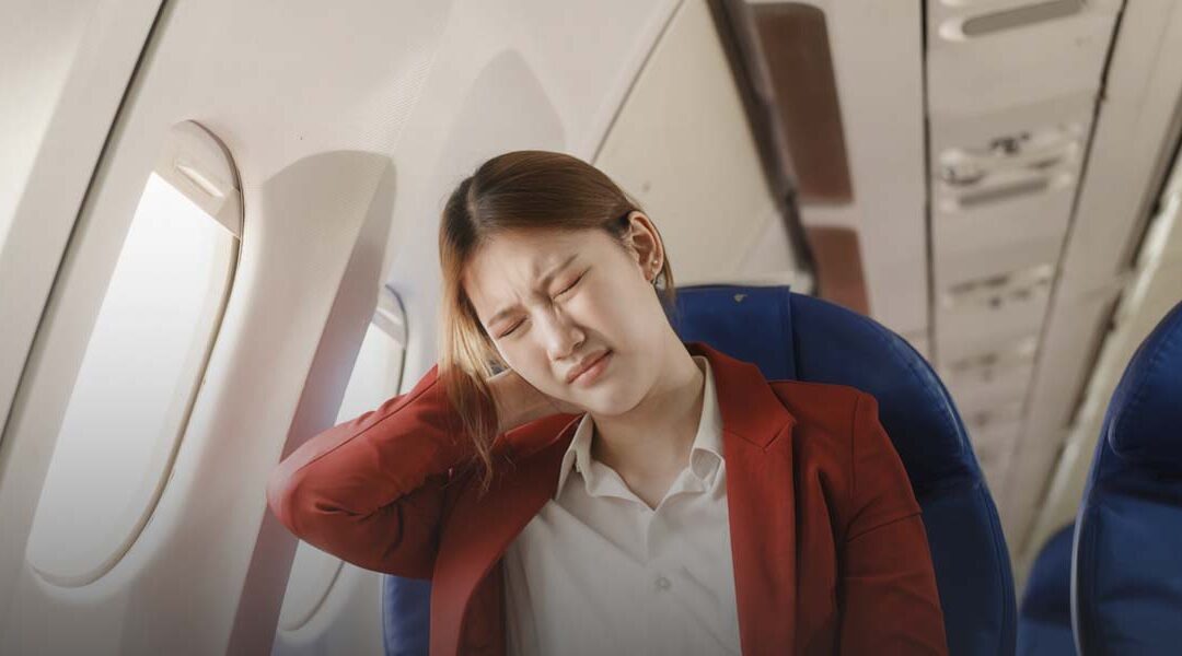 women on plane experiencing neck and back pain